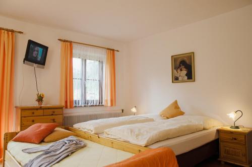 a bedroom with two beds and a window at Scheibenhof in Bad Gastein