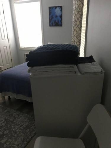 a bedroom with a bed and a chair next to a window at CLARENDON,SUPRLOCATION,8ppl,PRIVATE,METRO,PARK in Arlington