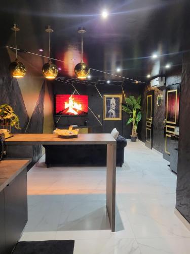 a living room with a table and a couch at Maloveroom, 2 Suites d'exceptions in Beaucroissant