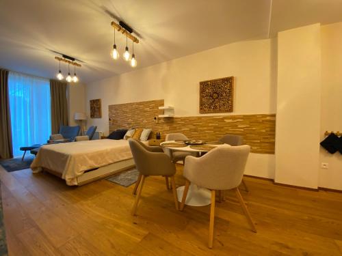 a bedroom with a bed and a table and chairs at Apartmány Impresia - Bernard in Vysoké Tatry