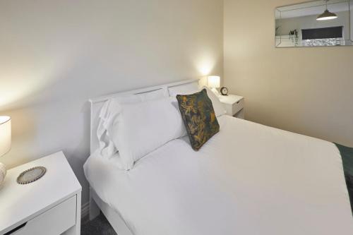 a bedroom with a white bed with a pillow at Host & Stay - Studio No.8 in Alnwick