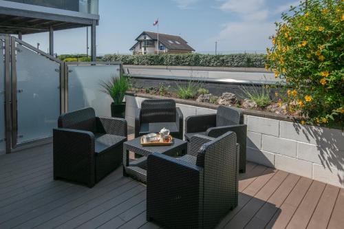 a patio with chairs and a table on a balcony at Best Western Lancaster Morecambe Lothersdale Hotel in Morecambe