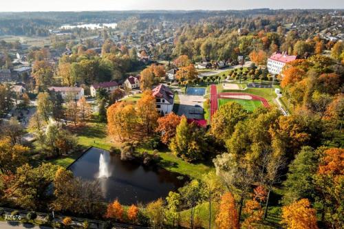 an aerial view of a park with a lake at Fukša Saules dzīvoklis in Madona