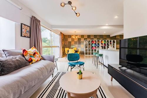 a living room with a couch and a table at NEW Cheerful Family Friendly Roma Norte Condo in Mexico City