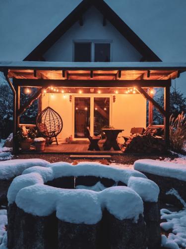 a house with a gazebo with lights on it at Domek Drwala k. Karpacza in Sosnówka
