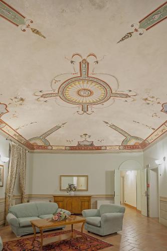 a living room with a painting on the ceiling at Relais Il Chiostro Di Pienza in Pienza