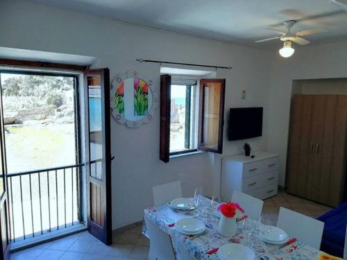 a dining room with a table and a balcony at Torre del Campese in Campese