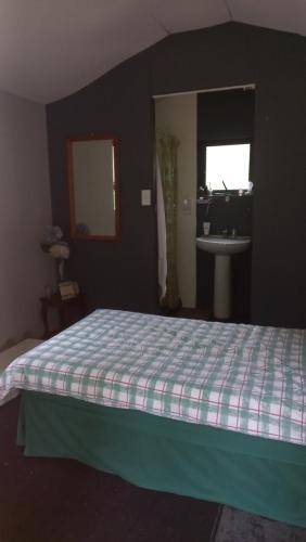a bedroom with a bed and a sink in a room at Me, myself, I Glamping in Pietermaritzburg