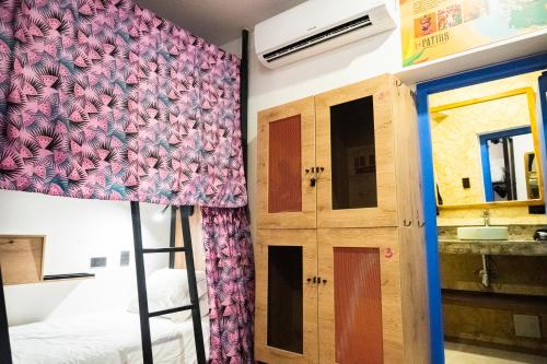 a room with a bed and a door with a curtain at Los Patios Hostel in Cartagena de Indias