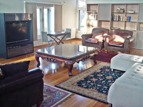 a living room with couches and a coffee table at The GoodFind Residency in Srinagar