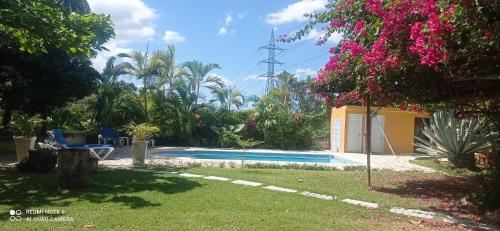 a pool in the backyard of a house at Los Palmares Guest House & Eventos in San Cristóbal