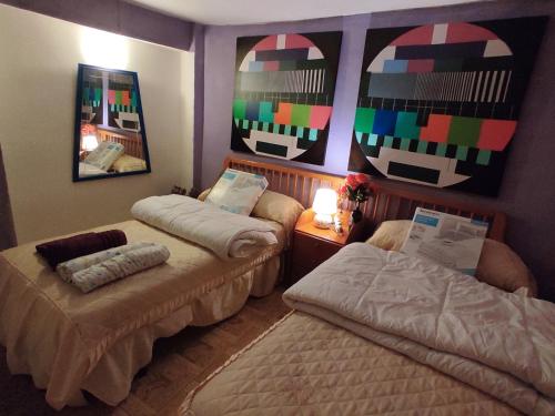 a bedroom with two beds and a mirror at Casa Terzia a 10 min de Logroño in Islallana