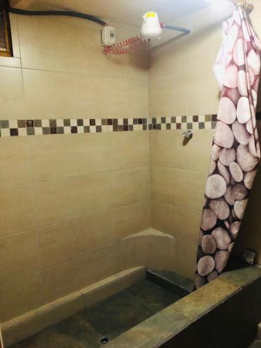 uma casa de banho com banheira e cortina de chuveiro em HOSPEDAJE las PRIMICIAS RIOBAMBA 104 em Riobamba