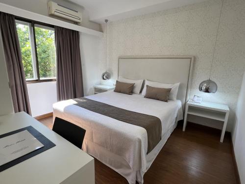 a hotel room with a large bed and a window at Hotel Alvear in Montevideo