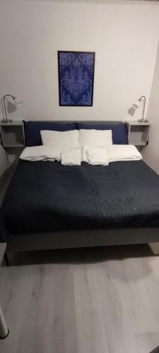 a bed with two pillows on it in a room at Villa Pikkumustikka in Töysä