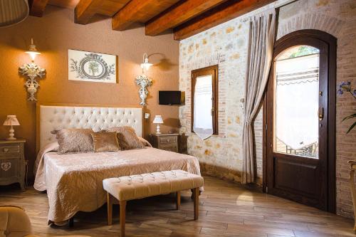 a bedroom with a bed and a large window at Relais Garden Cactus B&B in Favara