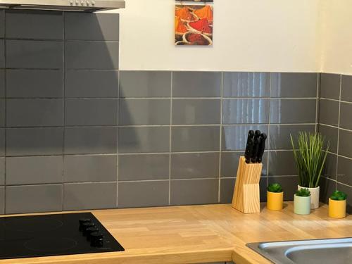 a kitchen with gray tiles on the wall at Luxury Double & Single Rooms with En-suite Private bathroom in City Centre Stoke on Trent in Stoke on Trent