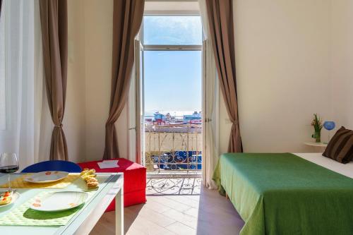 a bedroom with a bed and a window with a view at Palazzo Olivieri Amalfi Coast in Salerno