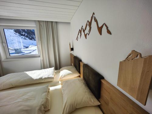 a hotel room with two beds and a window at Ferienhof zur Sonne in Tux