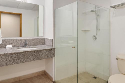 a bathroom with a shower and a sink and a toilet at Hotel Monterrey Macroplaza in Monterrey