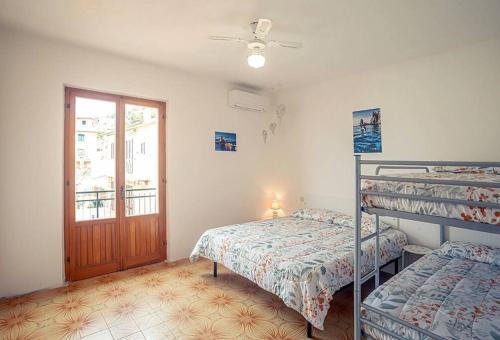 a bedroom with two bunk beds and a door at Maria Vittoria in Campese