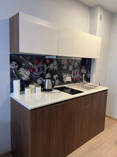 a kitchen with a sink and a counter top at Crystal Residence Apartment 224 in Bakuriani