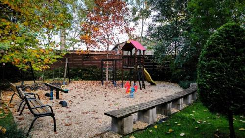 a playground with a slide and a bench and a park at Studio Viva - Cosy Flat in Budapest - Free Parking in Budapest