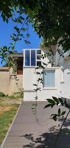 a white building with a window and a walkway at Gîte Le Bois d Argonne in Le Vieil-Dampierre