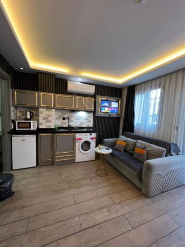 a living room with a couch and a kitchen at Taksim Larissa hotel suites in Istanbul
