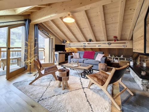 un salon avec un canapé et une table dans l'établissement Chalet Neuf · Proche Pistes · Terrasse · Sauna - FR-1-344-1161, à Praranger