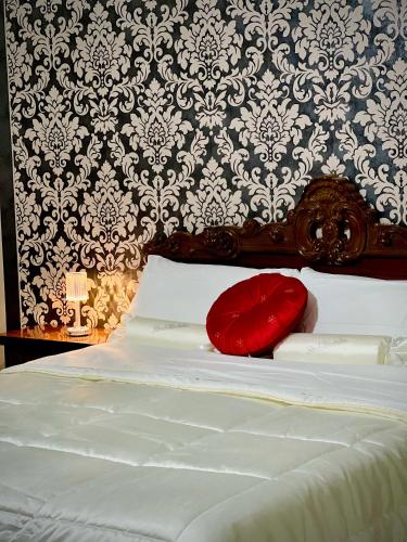 a red pillow sitting on top of a bed at Venice VIP Guest House in Mestre