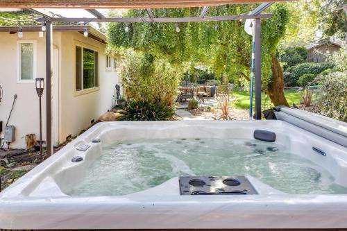 a jacuzzi tub in the backyard of a house at Modern Home in Napa Area with Hot Tub and Game Room! in Petaluma
