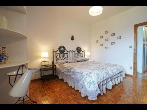 a bedroom with a bed and two lamps and a window at Cottage love Rivisondoli by FH in Rivisondoli