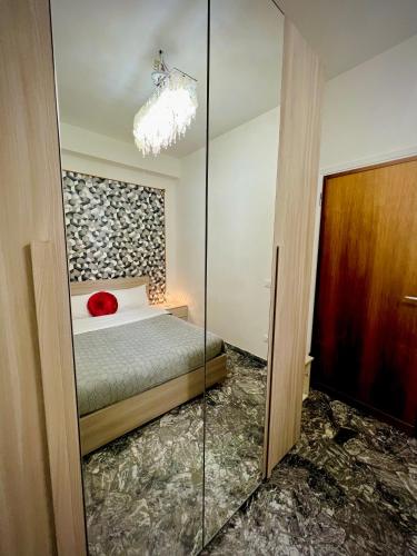 a bedroom with a bed and a glass door at Venice VIP Guest House in Mestre