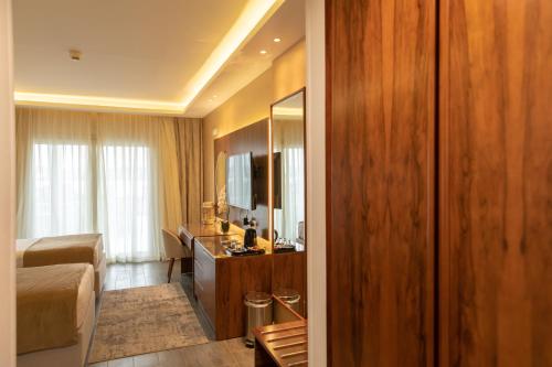 a bedroom with a bed and a sink and a mirror at Nile Club hotel in Cairo