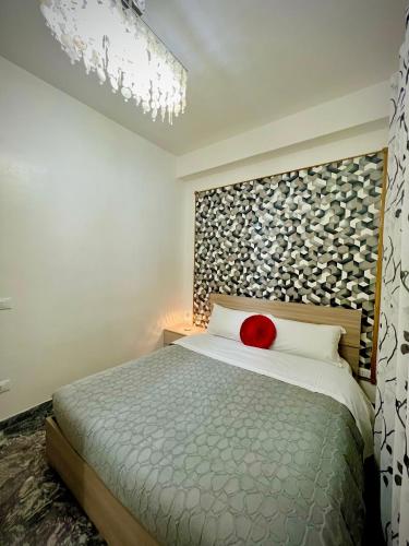 a bedroom with a bed with a red pillow on it at Venice VIP Guest House in Mestre
