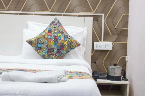 a bedroom with two beds with a pillow on it at JSB HOTEL in Faridabad
