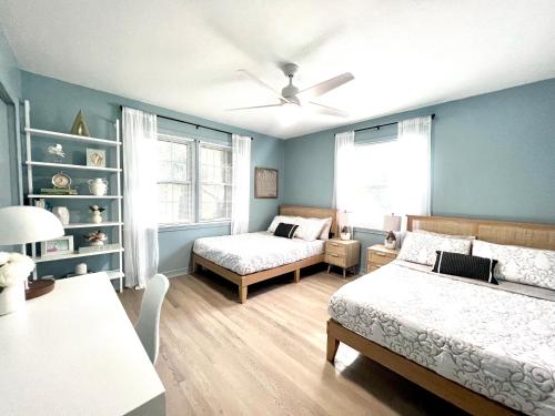 a bedroom with two beds and a table and a couch at Coastal Cottage By Vilano in St. Augustine