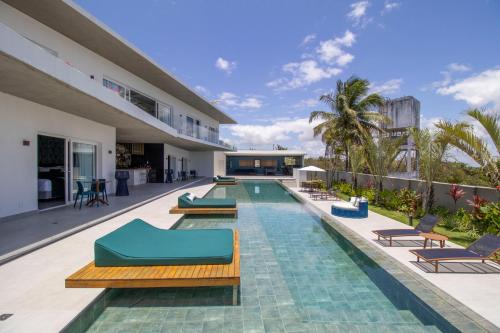 an outdoor swimming pool with lounge chairs and a resort at The View - Adults Only Resort in Pipa