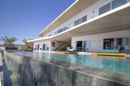 a swimming pool in front of a building at The View - Adults Only Resort in Pipa