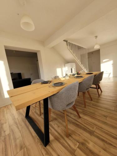 a dining room with a wooden table and chairs at Villa Bosna Near Dubrovnik very beautiful Villa entirely privatized swimming pool, jacuzzi, sauna, billiard, ping-pong in Ivanica
