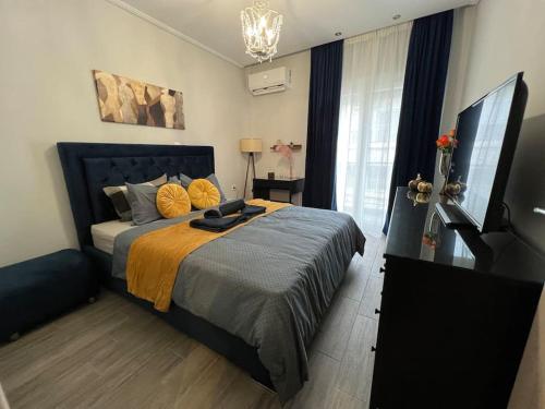 a bedroom with a bed and a flat screen tv at Luxury Privé Penthouse in Serres