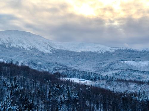 a view of a snow covered mountain with a lake at Gazdówka na Mosornym Groniu in Zawoja