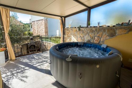 a large hot tub on a balcony with a view at Holiday Home Svjetlana in Risika