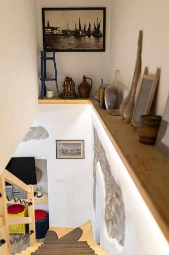 a room with a shelf with some items on it at Holiday Home Svjetlana in Risika