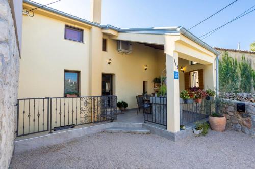 a house with a balcony with a fence at Holiday Home Svjetlana in Risika