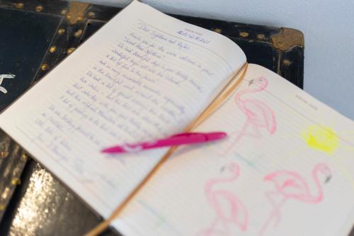 an open book with a red pen on a table at Holiday Home Svjetlana in Risika