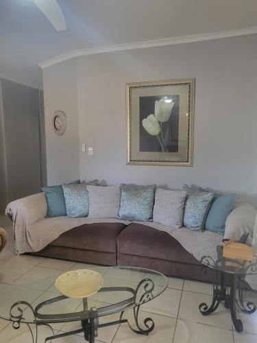 a living room with a couch and a table at Tranquility in Bloemfontein