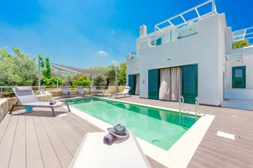 a villa with a swimming pool and a house at Villa Murtal in Gerani