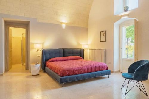 a bedroom with a bed with a red blanket at La volpe e l'uva Dimore in Montescaglioso